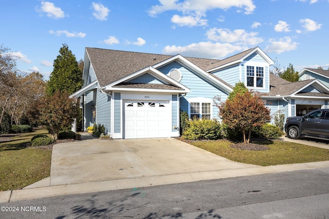 view of front of home with a front yard and a garage