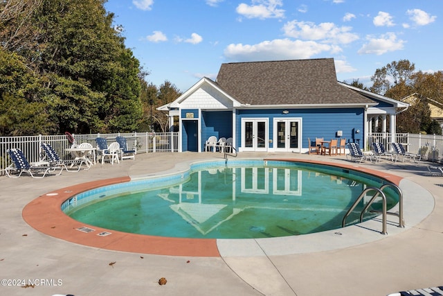 view of pool featuring a patio and french doors