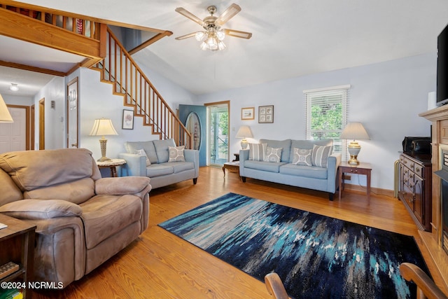 living room featuring a wealth of natural light, vaulted ceiling, hardwood / wood-style flooring, and ceiling fan