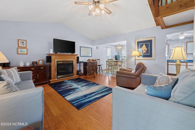 living room with vaulted ceiling, wood-type flooring, and ceiling fan