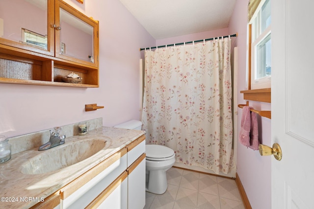 bathroom with vanity, toilet, and walk in shower