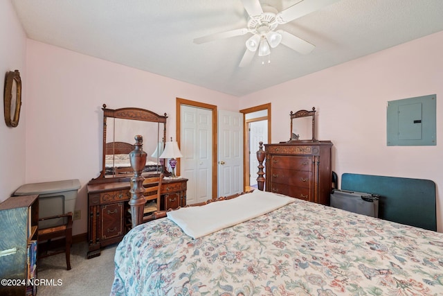 carpeted bedroom with electric panel, a textured ceiling, and ceiling fan