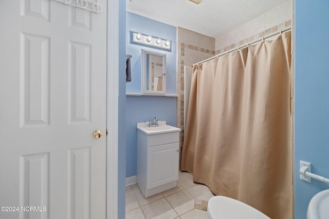 bathroom featuring a textured ceiling, toilet, vanity, a shower with curtain, and tile patterned flooring