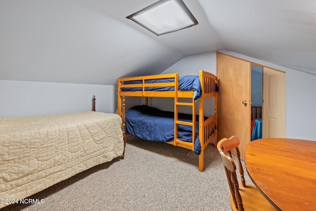 carpeted bedroom featuring lofted ceiling