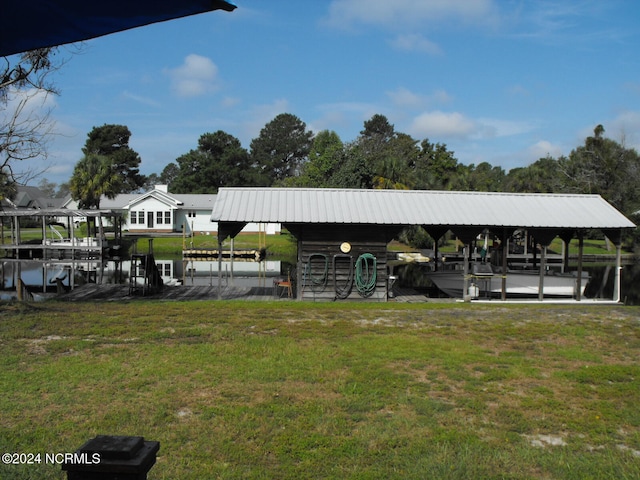 dock area featuring a water view and a lawn