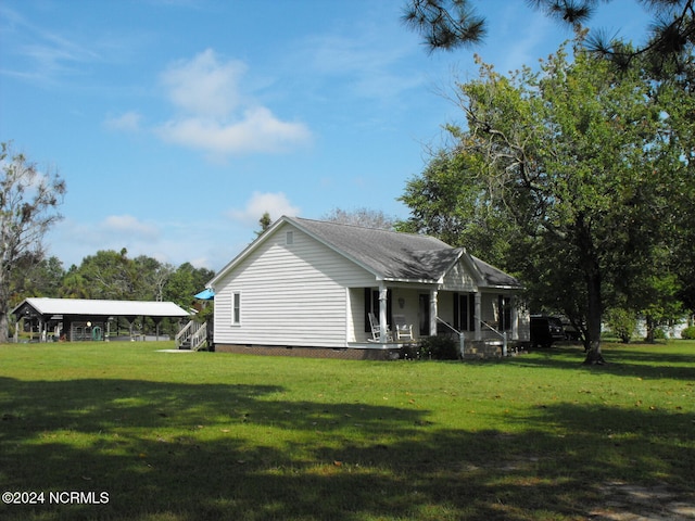 exterior space with a front yard and covered porch