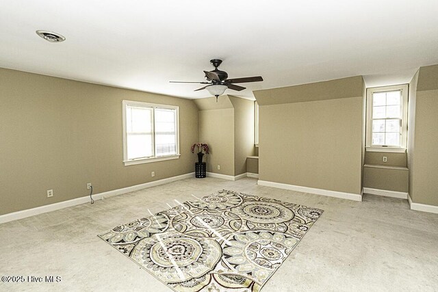 unfurnished bedroom featuring light colored carpet, two closets, visible vents, and baseboards