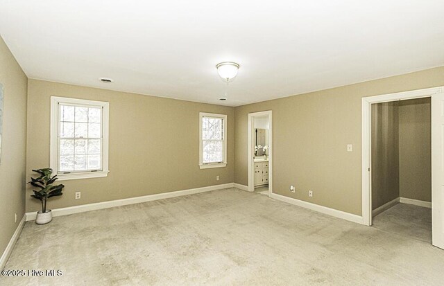 empty room with dark wood-style floors, a notable chandelier, crown molding, wainscoting, and wallpapered walls