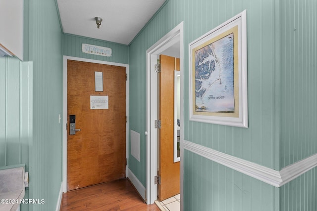 entryway featuring light hardwood / wood-style flooring and wood walls