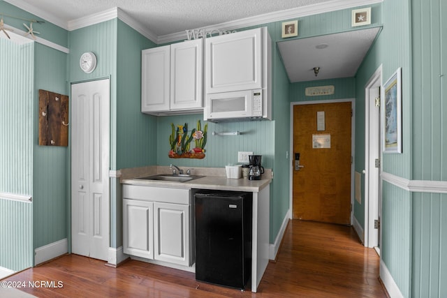 kitchen featuring dishwasher, crown molding, white cabinets, a textured ceiling, and dark hardwood / wood-style flooring