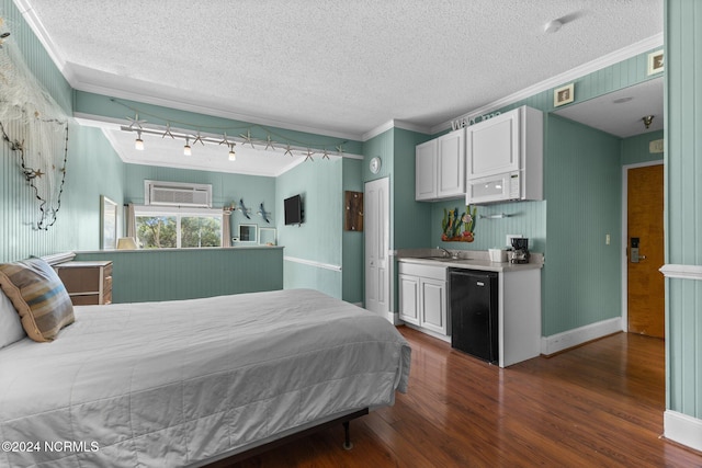 bedroom featuring dark hardwood / wood-style floors, black refrigerator, a wall mounted air conditioner, ornamental molding, and a textured ceiling