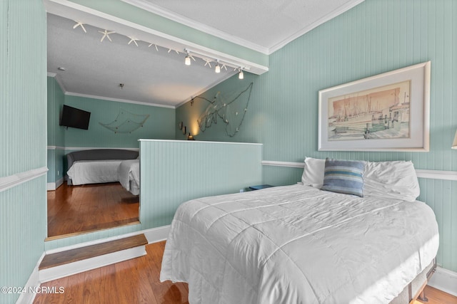 bedroom featuring hardwood / wood-style flooring and ornamental molding