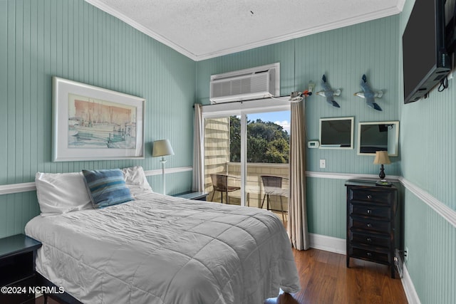 bedroom with ornamental molding, an AC wall unit, dark wood-type flooring, and a textured ceiling