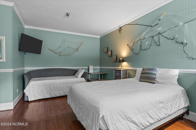 bedroom with ornamental molding, a textured ceiling, and hardwood / wood-style flooring