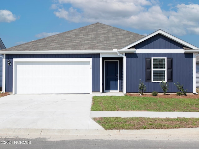 single story home with a front yard and a garage