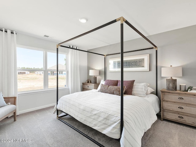 bedroom with light colored carpet