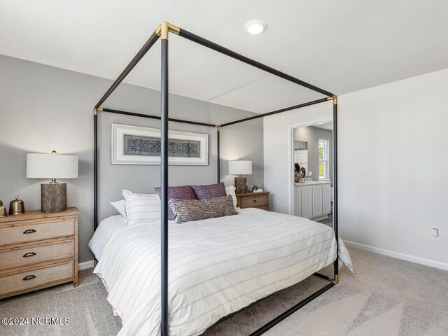 bedroom featuring light carpet