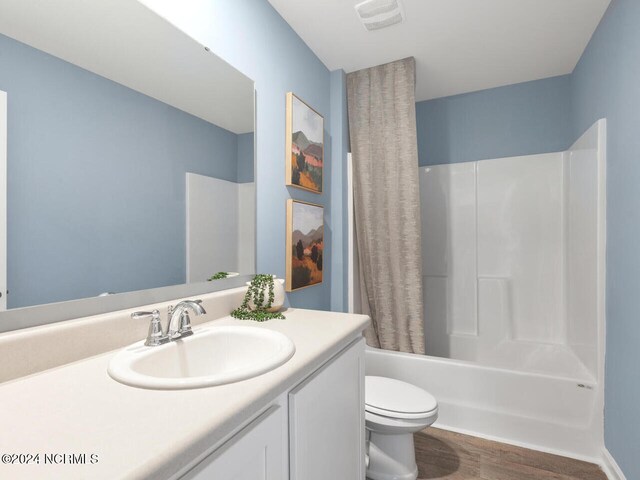 full bathroom featuring toilet, vanity, shower / bath combo, and hardwood / wood-style flooring