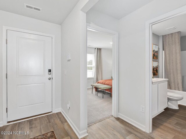 foyer entrance with light hardwood / wood-style flooring