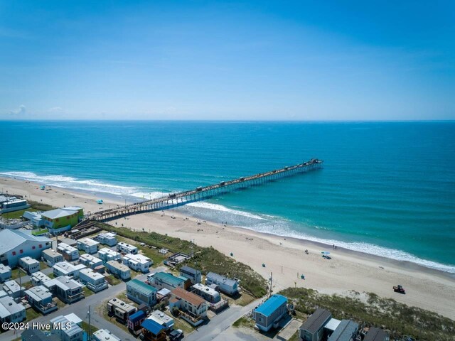 drone / aerial view featuring a beach view and a water view