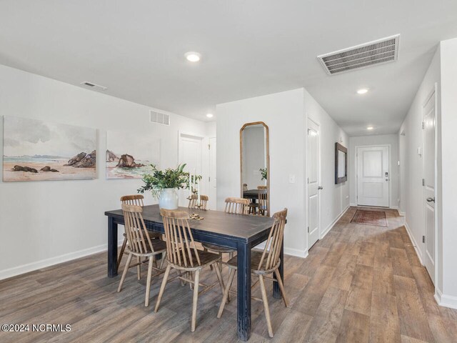 dining space with wood-type flooring