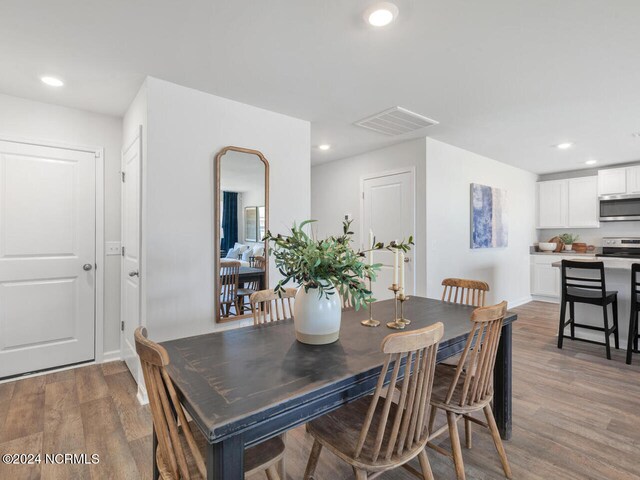 dining space featuring wood-type flooring