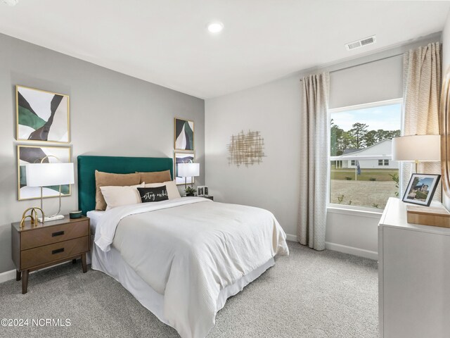 bedroom with light colored carpet