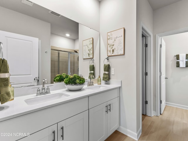 bathroom with vanity, hardwood / wood-style flooring, and an enclosed shower