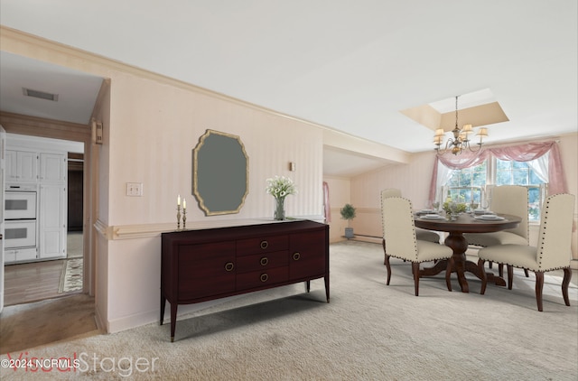 dining room featuring light carpet, an inviting chandelier, and baseboard heating