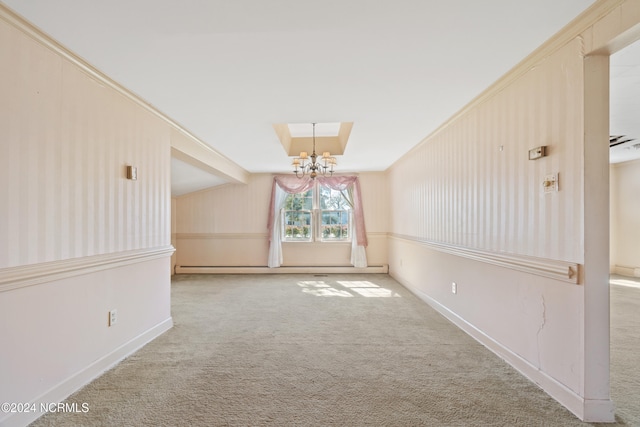 spare room featuring baseboard heating, crown molding, carpet flooring, and an inviting chandelier