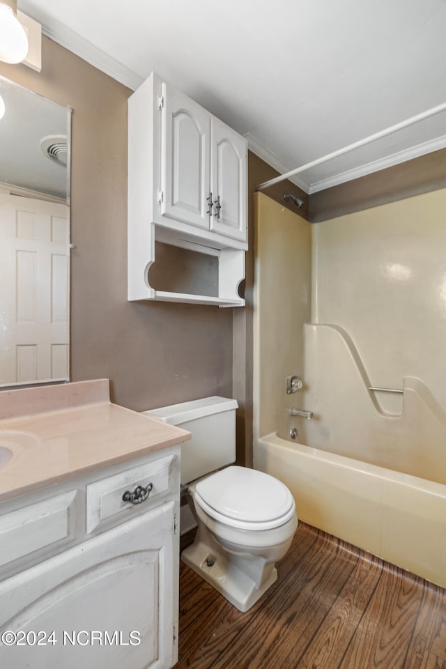 full bathroom featuring shower / tub combination, hardwood / wood-style flooring, toilet, vanity, and crown molding