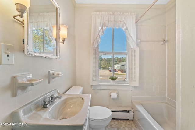 full bathroom with sink, a baseboard heating unit, ornamental molding, toilet, and tiled shower / bath combo