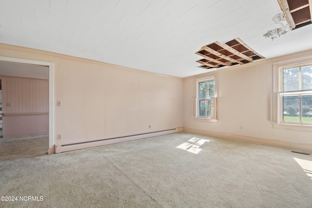 unfurnished room featuring ornamental molding, a baseboard heating unit, and light colored carpet