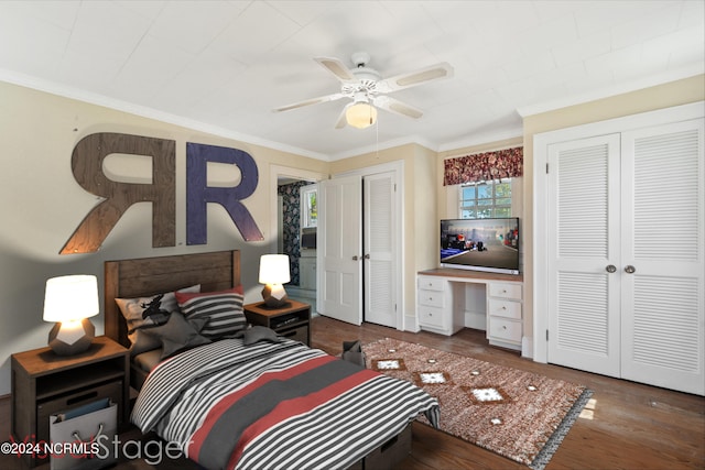 bedroom with built in desk, crown molding, dark hardwood / wood-style flooring, and ceiling fan