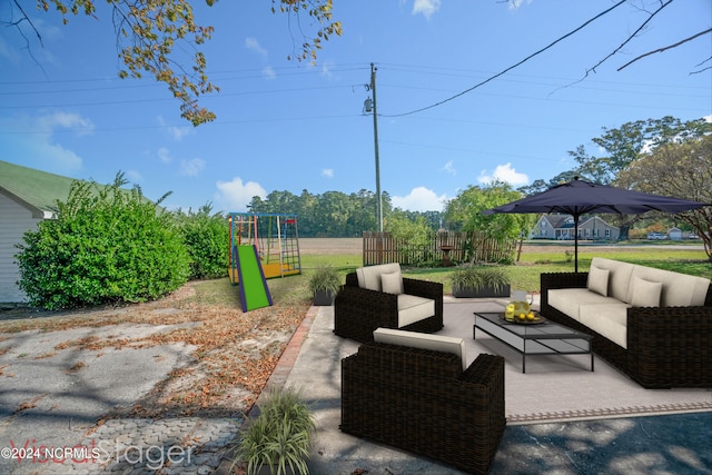 view of patio featuring a playground and outdoor lounge area