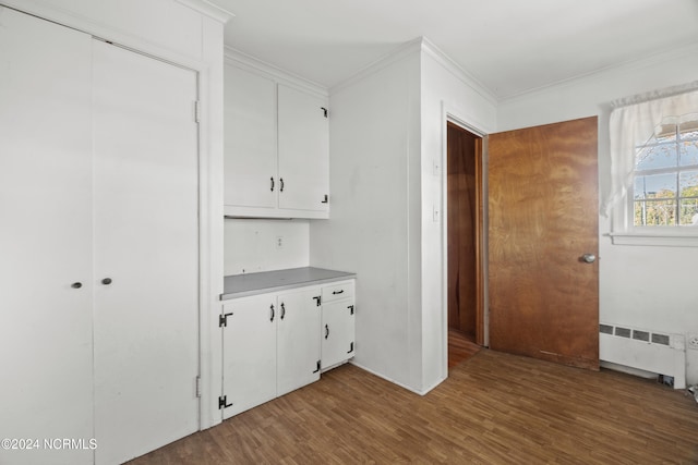 interior space featuring crown molding, radiator heating unit, and wood-type flooring