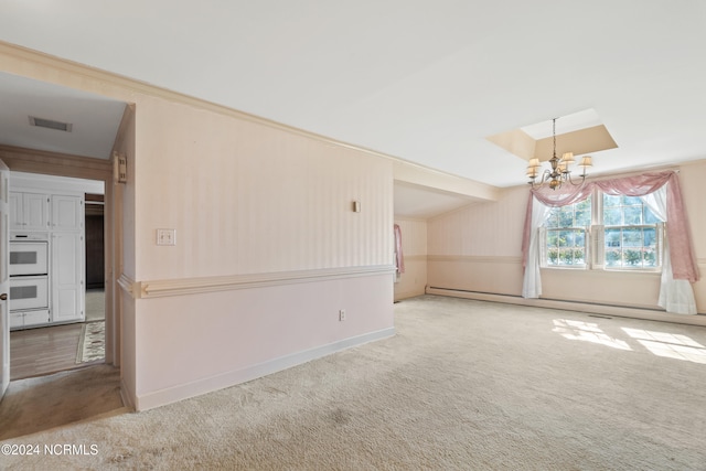 unfurnished living room with an inviting chandelier, a baseboard heating unit, and carpet floors