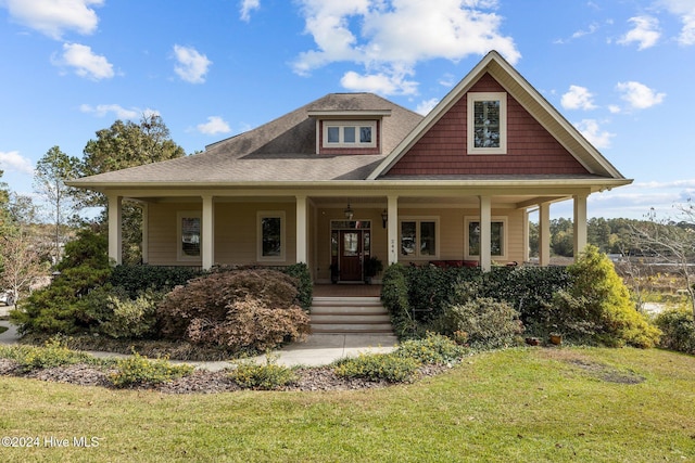 view of front of property featuring covered porch and a front lawn