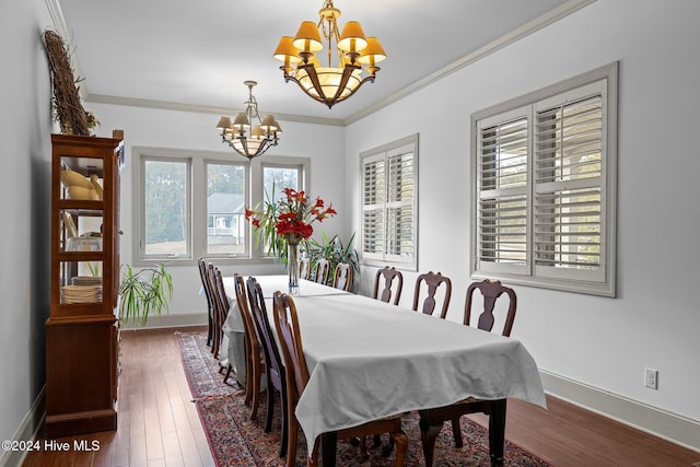 dining area featuring a chandelier, crown molding, and dark wood-type flooring