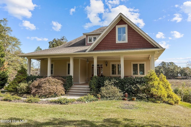 view of front of house with a porch and a front lawn