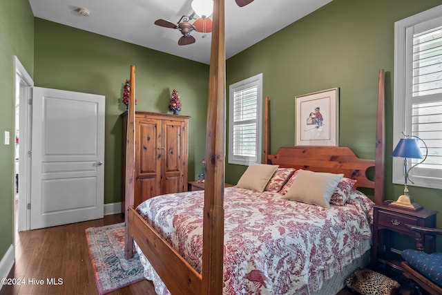 bedroom featuring multiple windows, ceiling fan, and dark hardwood / wood-style floors