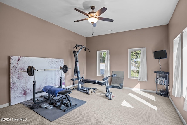 exercise room featuring ceiling fan and light carpet