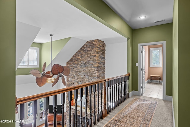 hallway with light colored carpet