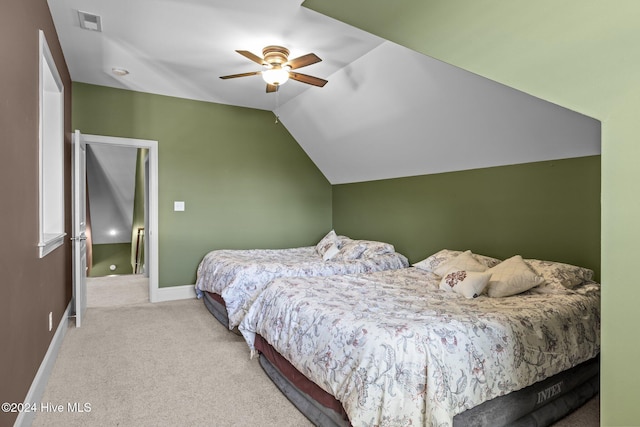 bedroom featuring lofted ceiling, ceiling fan, and light carpet