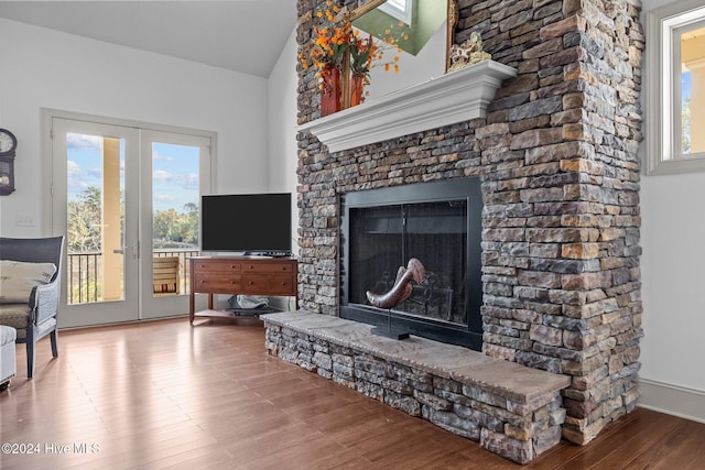 living room featuring a wealth of natural light, a fireplace, and hardwood / wood-style flooring