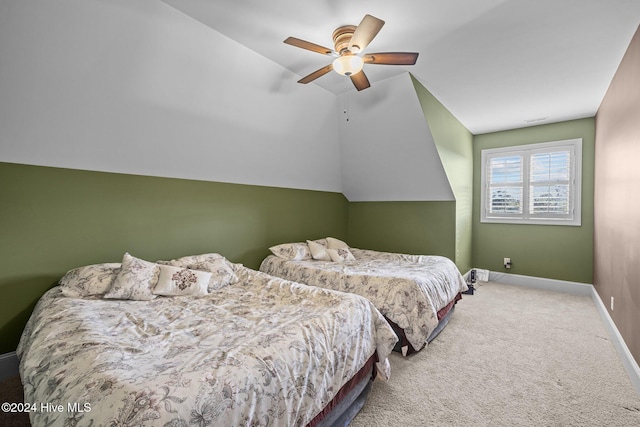 carpeted bedroom with vaulted ceiling and ceiling fan