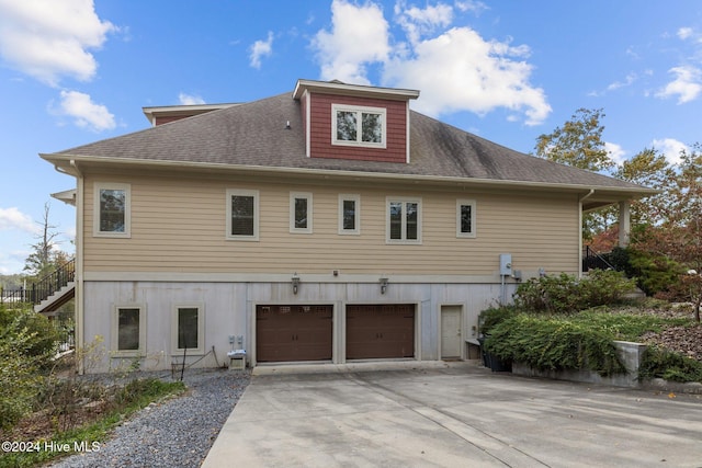 rear view of house featuring a garage