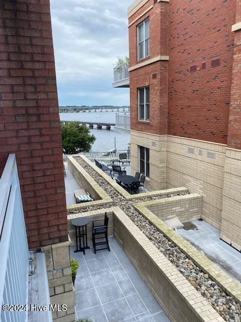 balcony with a patio area and a water view