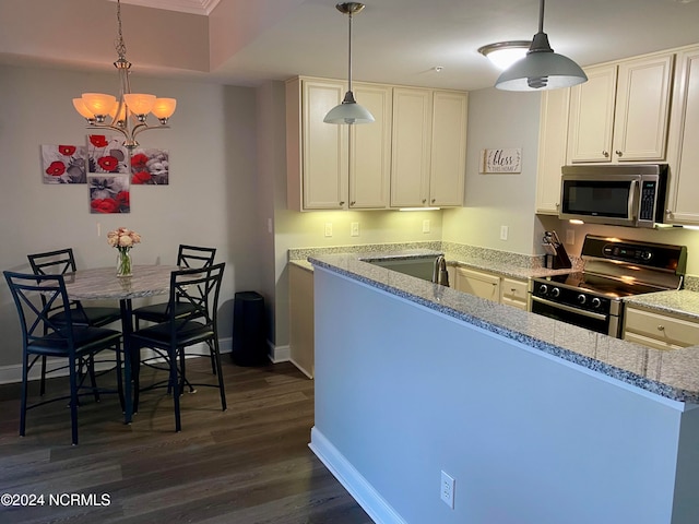 kitchen featuring dark wood-type flooring, appliances with stainless steel finishes, decorative light fixtures, light stone counters, and a chandelier