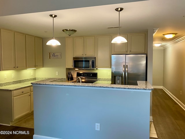 kitchen featuring appliances with stainless steel finishes, dark hardwood / wood-style flooring, ornamental molding, and pendant lighting